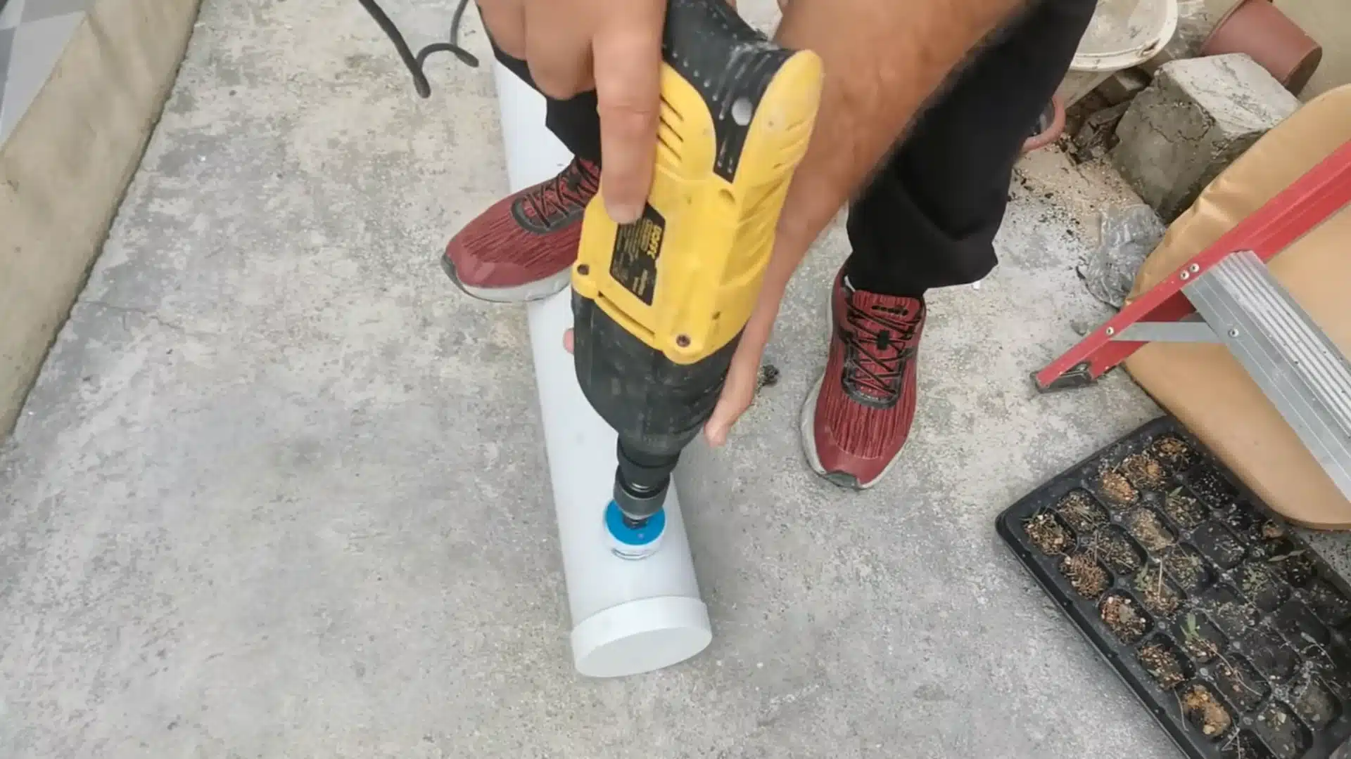 drilling planting holes in pvc pipe for a diy hydroponic system using a hole saw tool