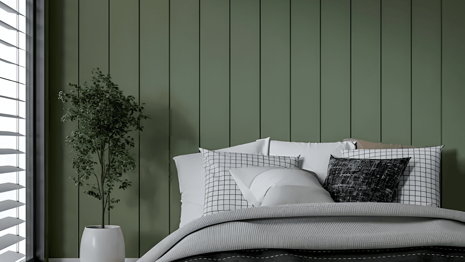 minimalist bedroom with green paneled wall cozy bed and potted plant by window