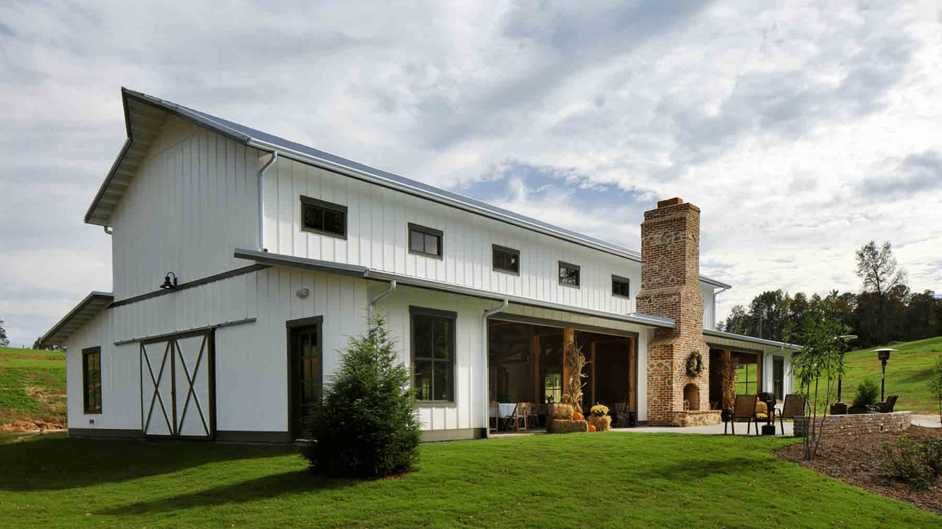 pole barn house with metal roof spacious interior and economical post frame construction in a rural landscape