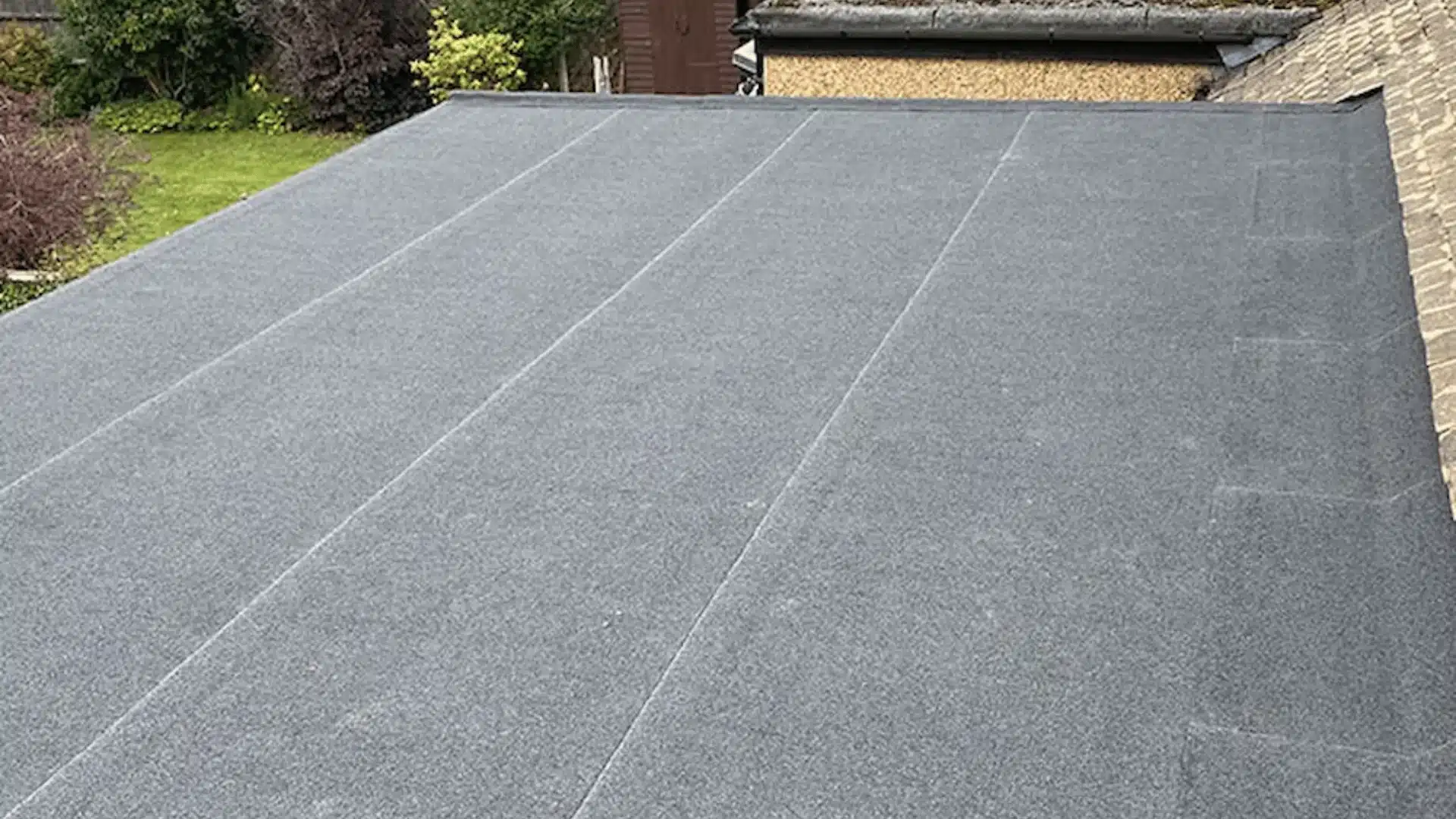 Flat gray roof surface with seams and a textured waterproof membrane installation