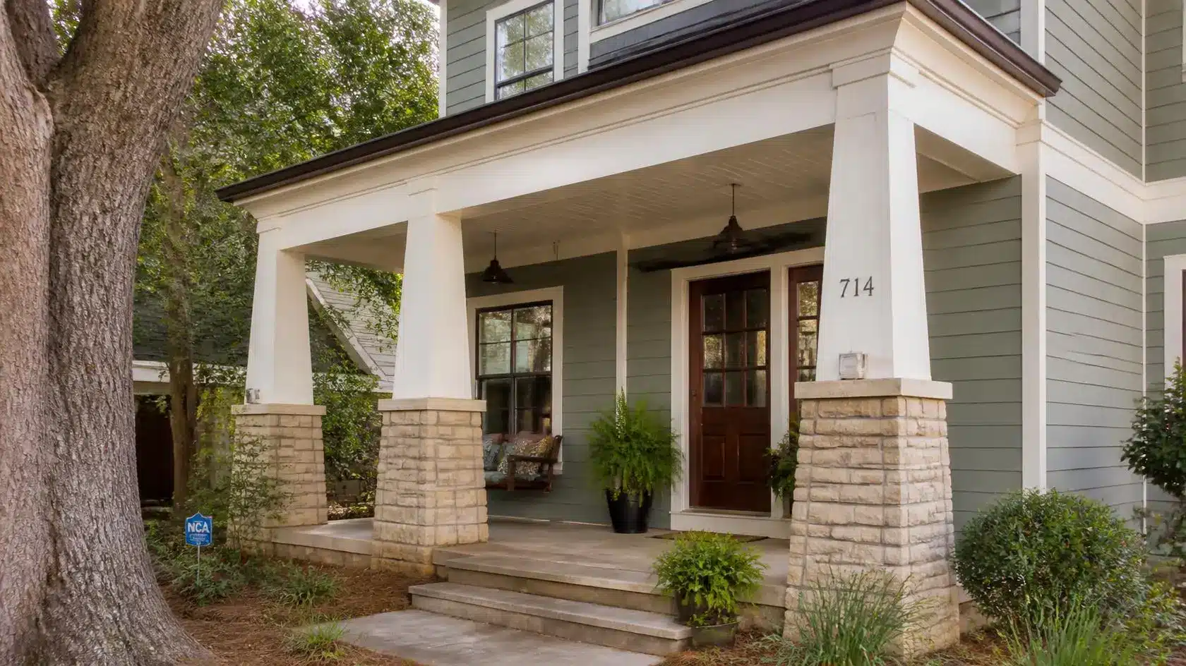 apered porch columns with wide bases adding character, architectural detail, and timeless style to a home exterior