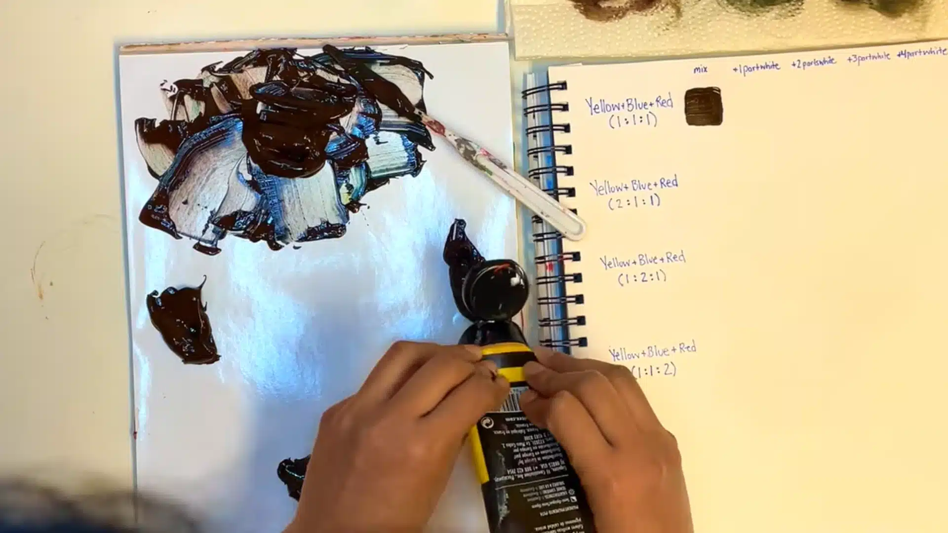 Adding extra yellow paint to a brown mixture to create a warmer golden brown shade.