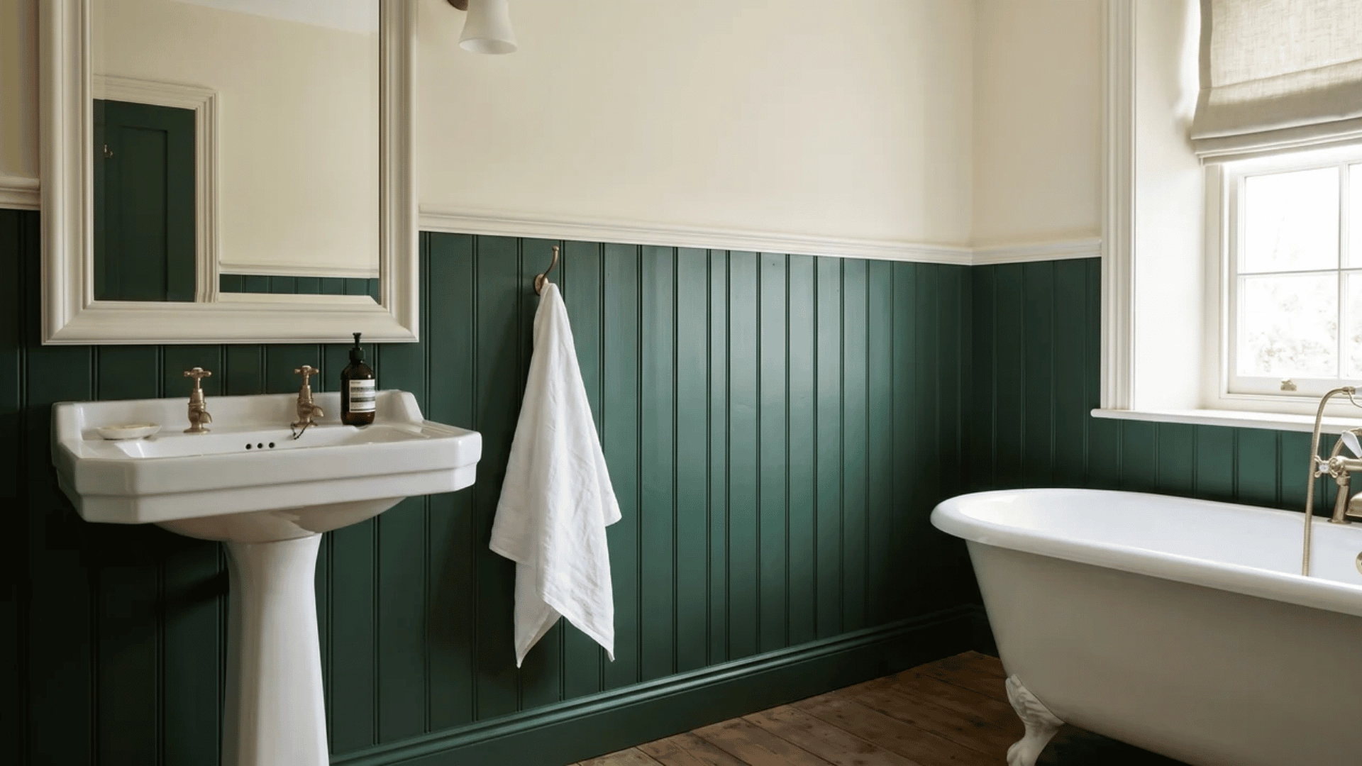 Dark green tongue-and-groove bathroom wall panelling