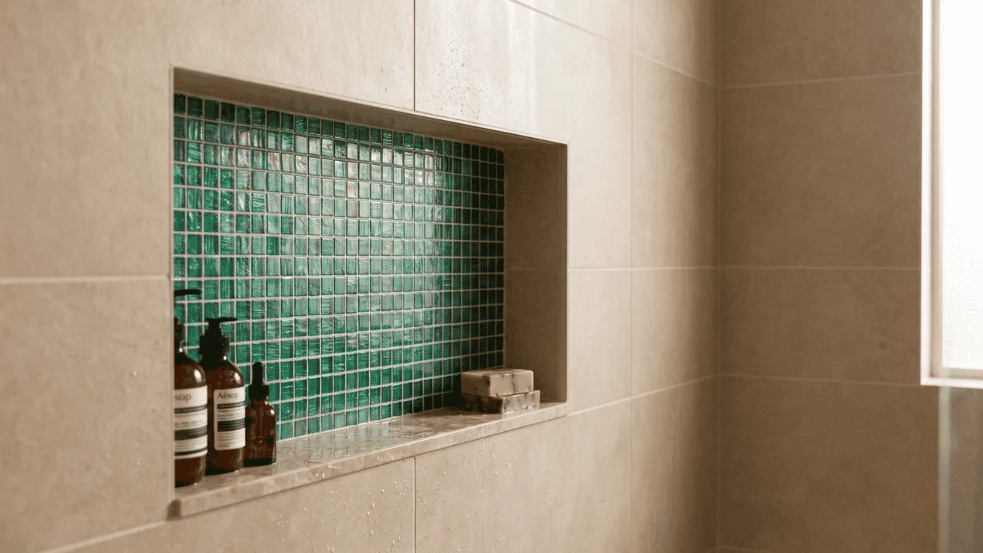 Emerald green mosaic shower niche with surrounding tiles
