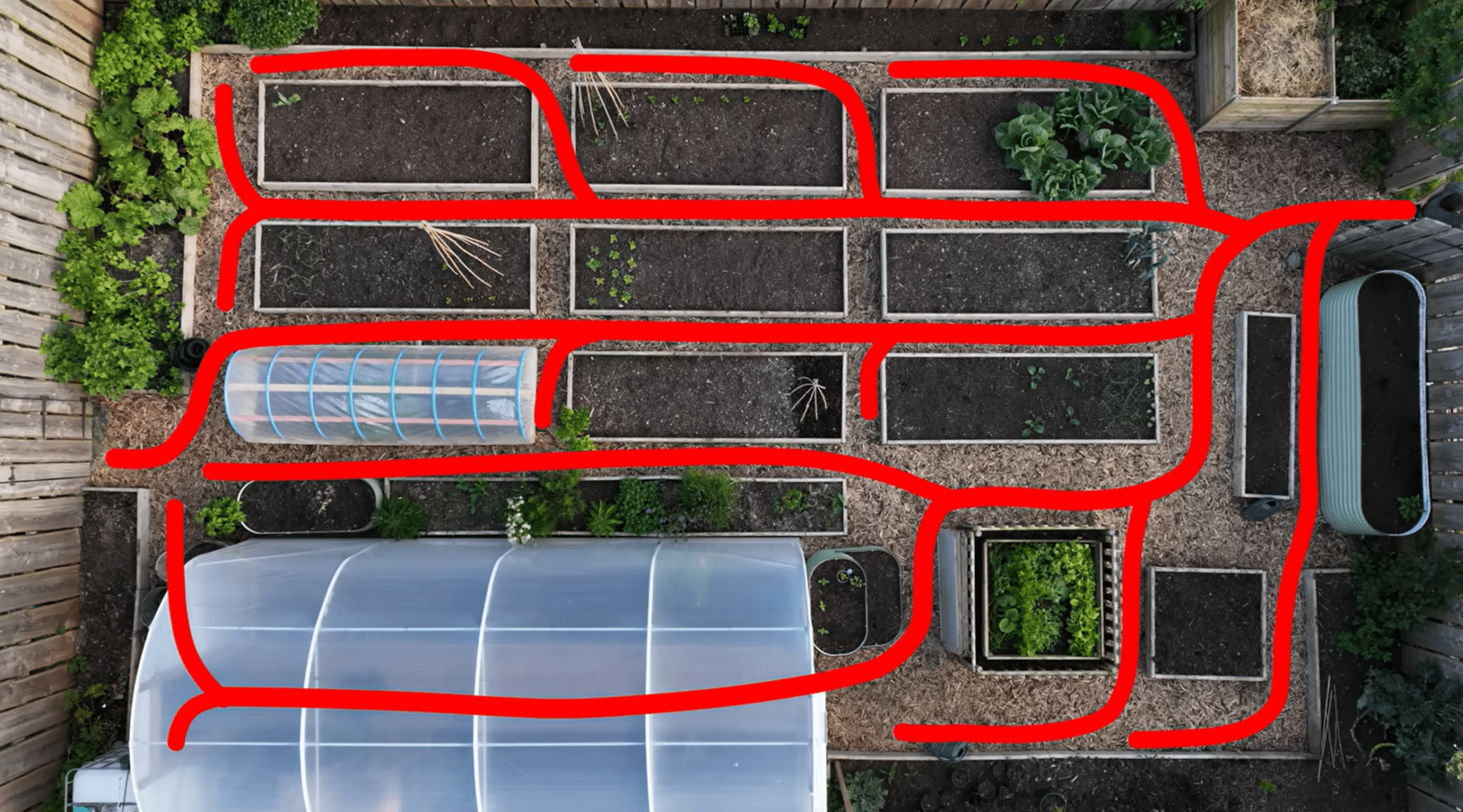Garden layout showing pathways connecting raised beds and growing areas in a potager design.