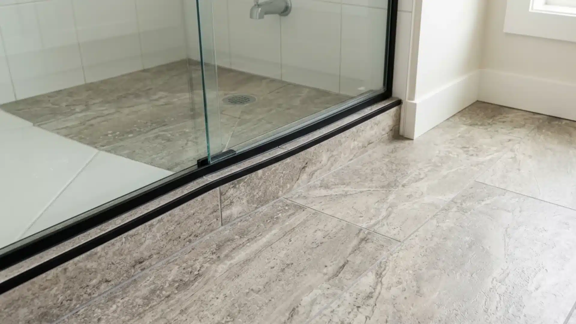 luxury vinyl tile flooring with stone look pattern installed in a bright bathroom corner
