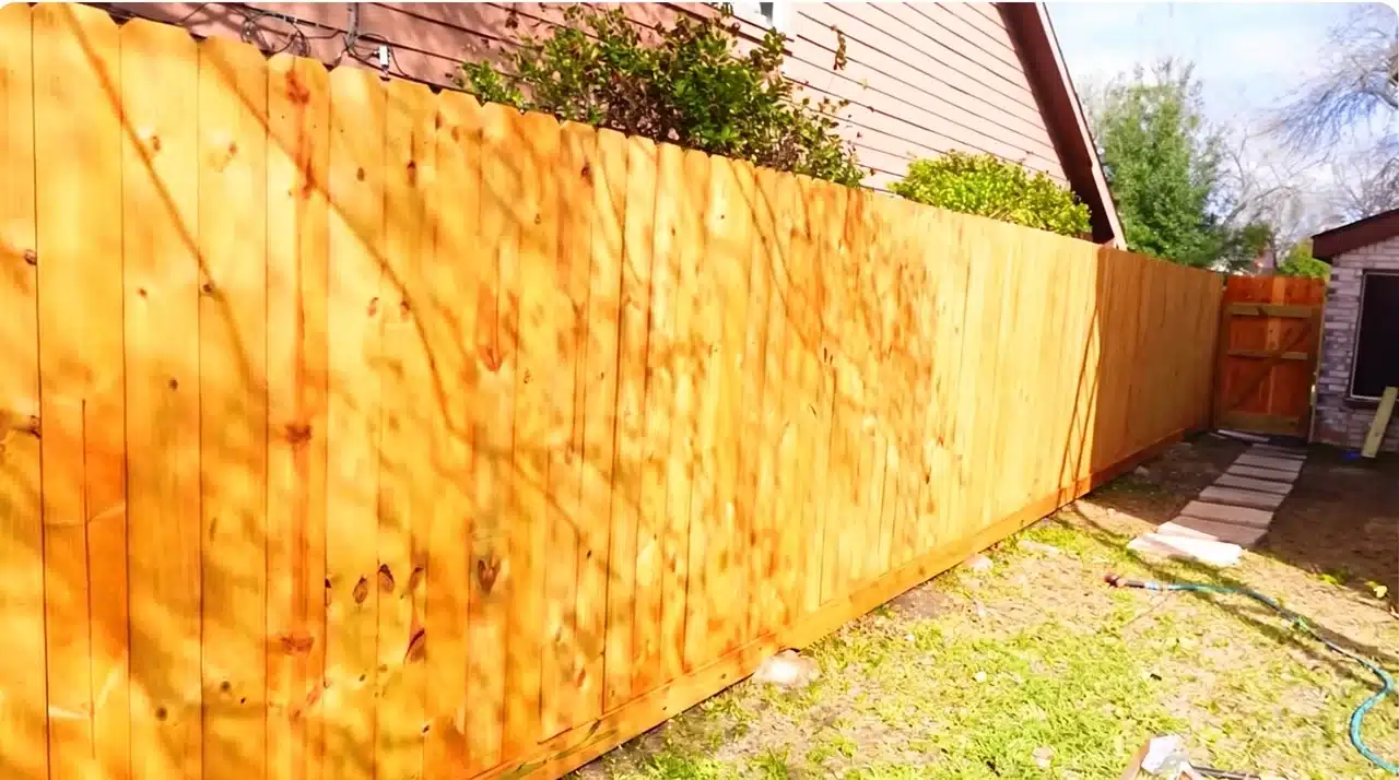 Finished wooden fence showing proper staining and maintenance for long-term durability