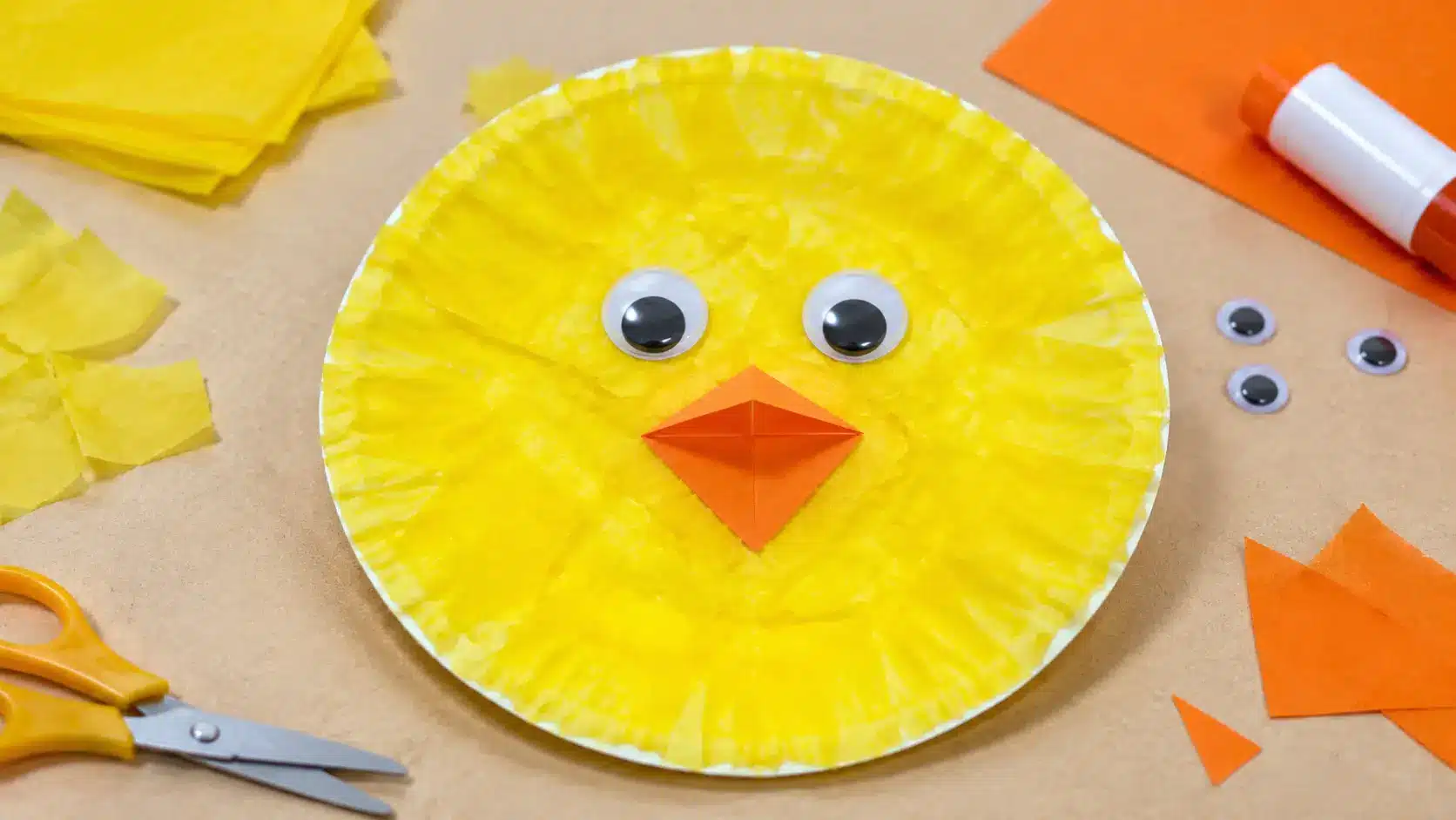 Yellow paper plate chick craft with orange beak