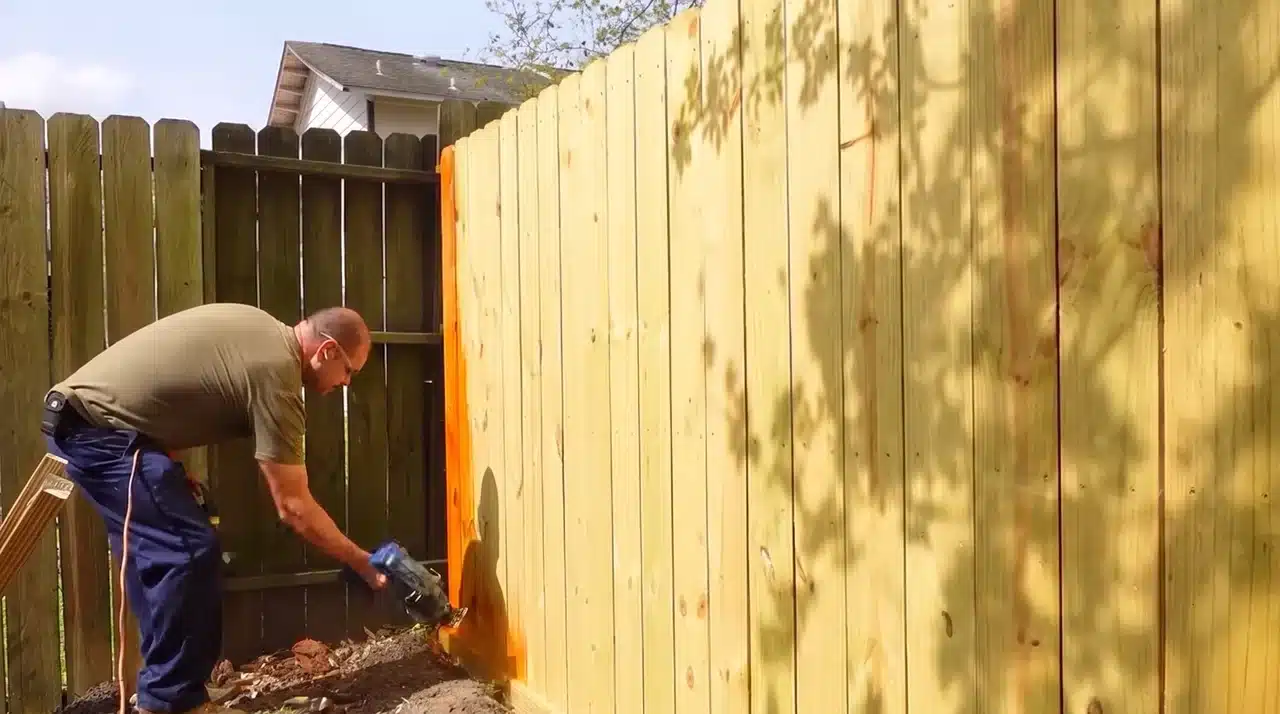 Installing a wooden fence gate with diagonal support braces and heavy-duty hardware