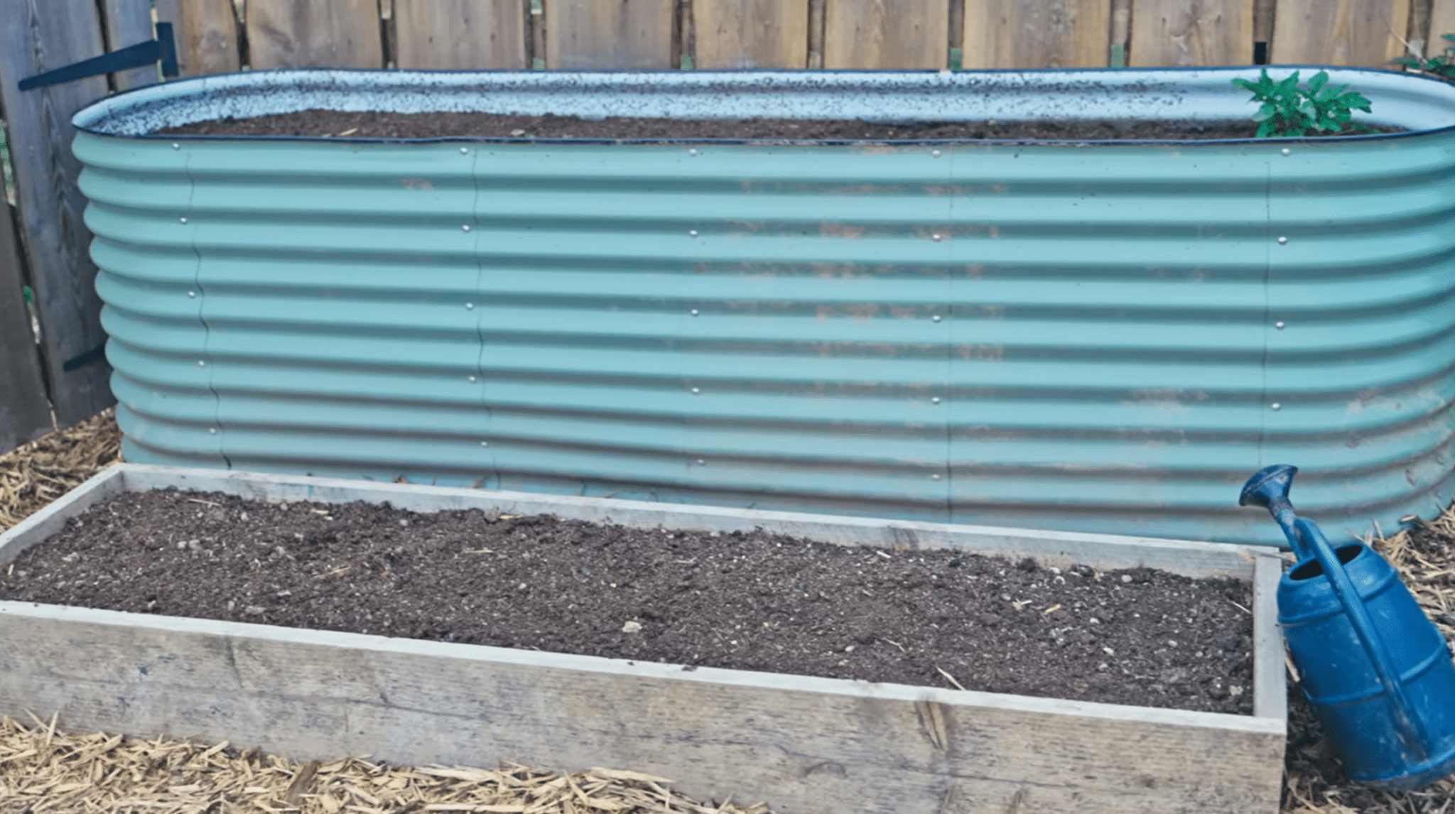 Raised garden beds filled with prepared soil ready for planting in a potager garden.