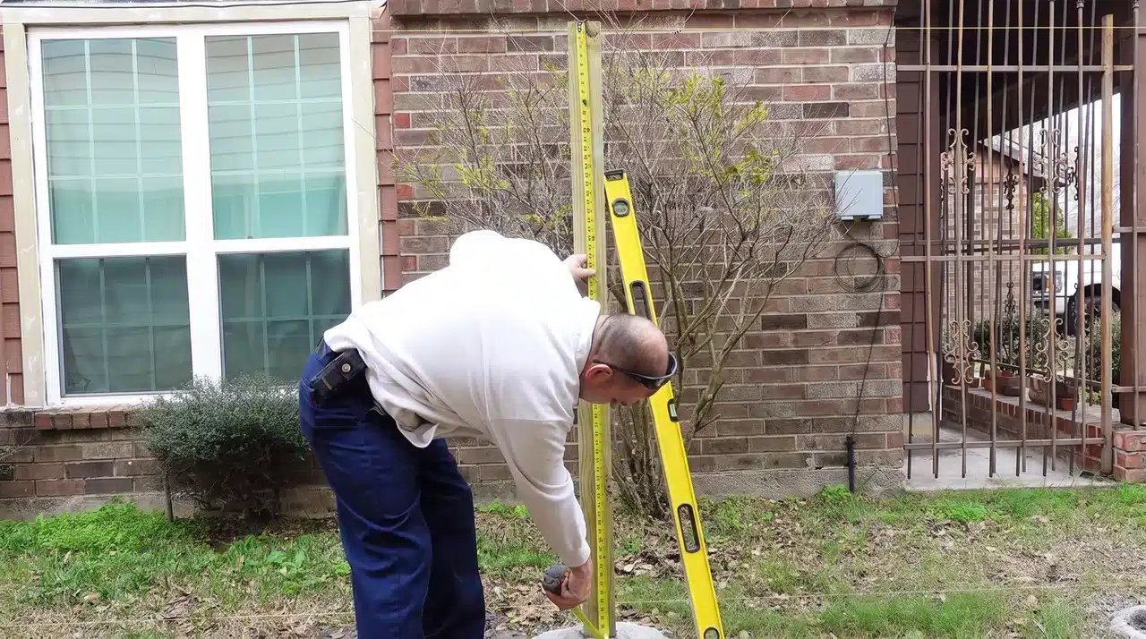 Leveling a wooden fence post and installing concrete support for a strong fence frame