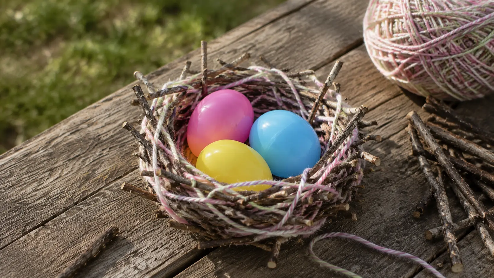 Twig and yarn nest with Easter eggs