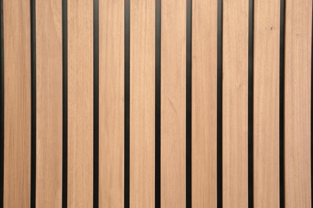 Light wood slatted wall panel with black vertical accents